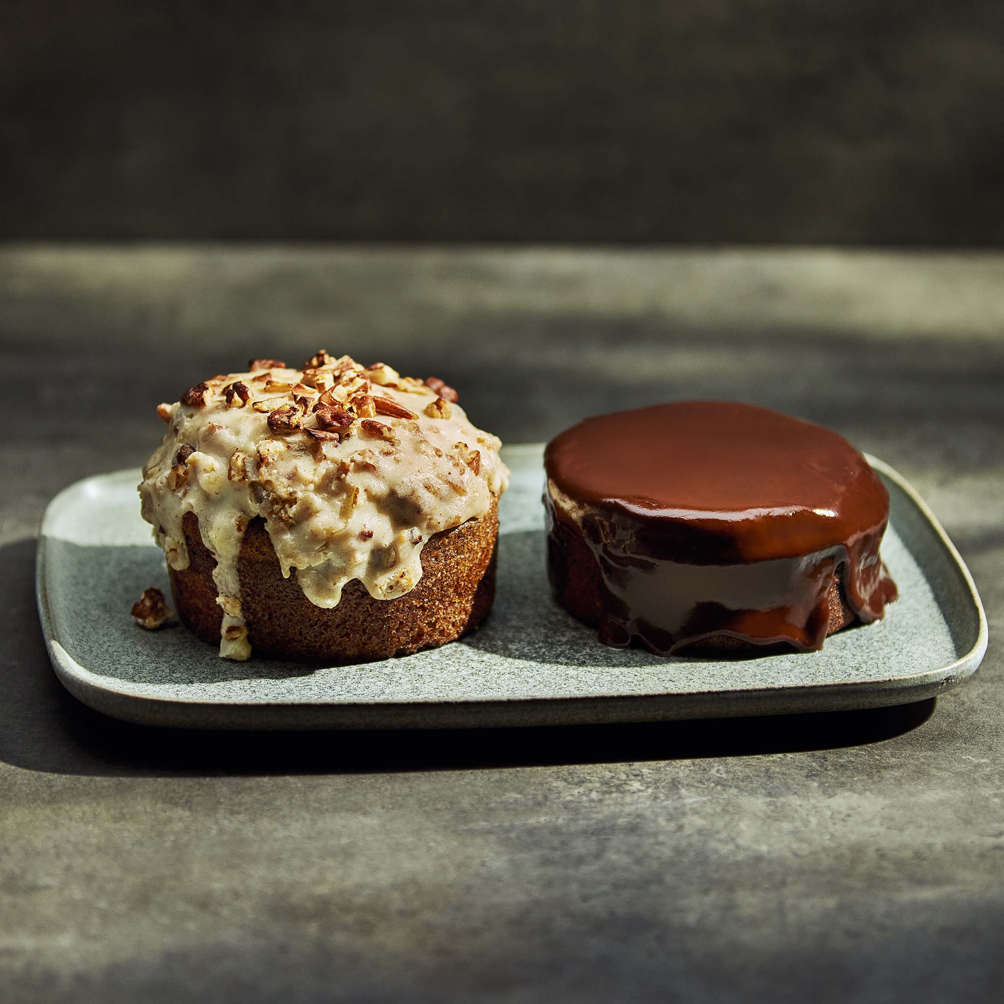 Two desserts on a gray plate with a dark background